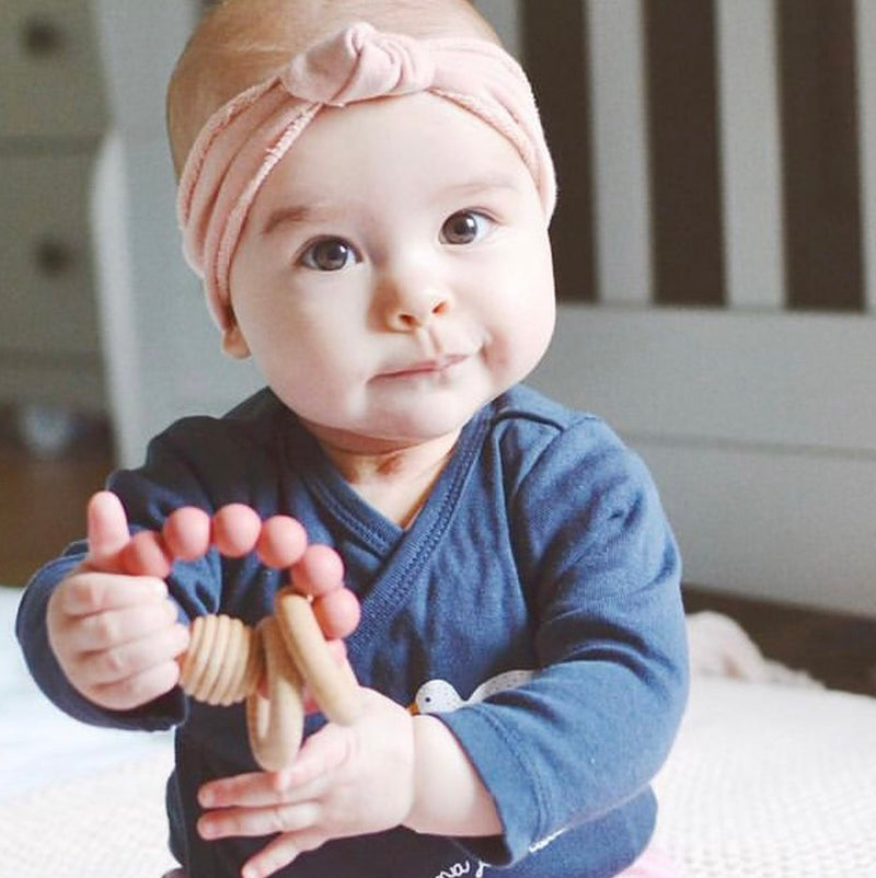A baby with a Silicone Teething Toy